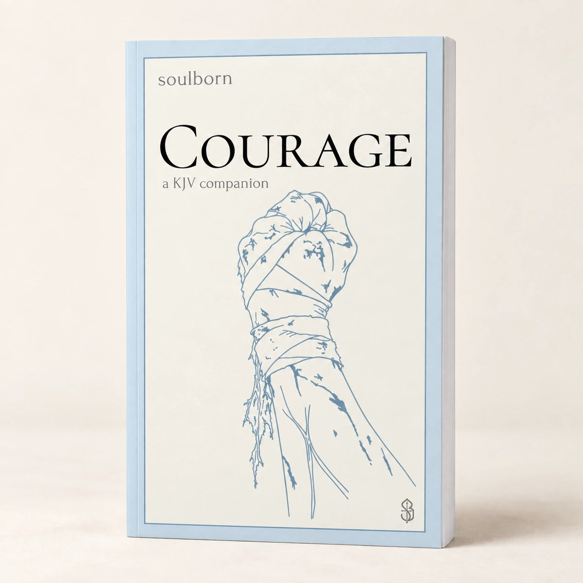 Courage — book photograph on a warm cream background